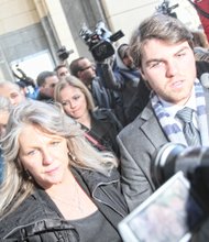 Maureen McDonnell walks through a bevy of media as she leaves the federal courthouse in Downtown with her son, Bobby, and daughter, Rachel, after her sentencing last Friday