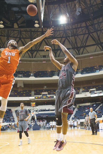 High-flying Virginia State University forward Tyrece Little, left, shown in the 2015 Freedom Classic, was named the CIAA’s Defensive Player of the Year. Here, he blocks a shot taken by Virginia Union University’s Ronald Whaley.
