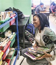 Teacher Cierra Claughton selects books for her seventh- grade English class at Clark Springs Elementary School Wednesday. She and other teachers, administrators and students made the transition this week into the West End elementary school after they were forced to move from Elkhardt Middle School in South Side because of a mold infestation.