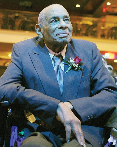 Former Richmond City Council colleagues who brought black political power to City Hall in 1977 take part in a recognition ceremony that Mayor Dwight C. Jones hosted Wednesday night at The Hippodrome Theater in Jackson Ward. Right, Henry W. “Chuck” Richardson chats with Claudine McDaniel, who stood in for her mother, the late Claudette Black McDaniel, Willie J. Dell and Henry L. Marsh III, who became the city’s first African-American mayor with the votes of his colleagues. Left, Walter T. Kenney, the fifth honoree, listens to the program with a reflective expression.
