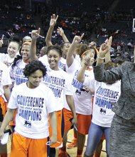 Virginia State University Athletic Director Peggy Davis, right, celebrates with the Trojans’ women’s basketball team following its 73-49 blowout of Lincoln University in the CIAA Tournament championship game last Saturday in Charlotte, N.C.