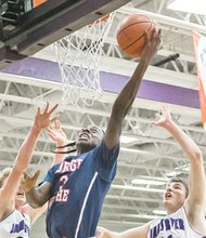George Wythe High School’s Maliek White stretches toward the hoop in a January basketball game against Chesterfield’s James River High School.