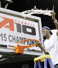 Virginia Commonwealth University basketball star Briante Weber, who suffered a season-ending knee injury in January, cuts down the net as the Rams celebrate their Atlantic 10 Conference Tournament title after Sunday’s 71-65 win over University of Dayton in New York. Winning the title gives the Rams an automatic berth in the NCAA Tournament.