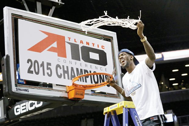 Virginia Commonwealth University basketball star Briante Weber, who suffered a season-ending knee injury in January, cuts down the net as the Rams celebrate their Atlantic 10 Conference Tournament title after Sunday’s 71-65 win over University of Dayton in New York. Winning the title gives the Rams an automatic berth in the NCAA Tournament.