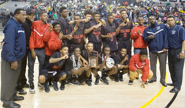 The George Wythe High School boys basketball team and coaches strike a winning pose following the team’s 80-60 win over Spotswood High of Rockingham County in the 3A state championship game at the Siegel Center. 