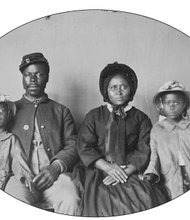 An unidentified Union soldier poses with his wife and two daughters in this photograph taken circa 1863-1865.