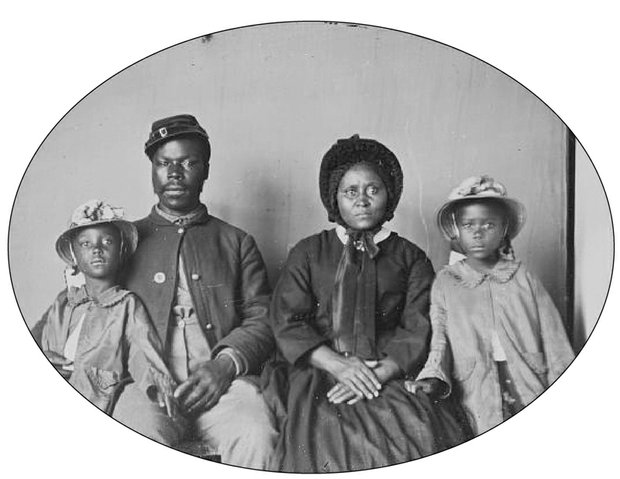 An unidentified Union soldier poses with his wife and two daughters in this photograph taken circa 1863-1865.