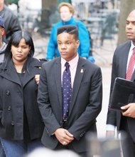 University of Virginia student Martese Johnson, center, stands with his attorney, Daniel Watkins, right, and his mother, Dychea, and older brother, Michael, last Thursday at a news conference before his attorney read a statement from the honors student about his arrest.