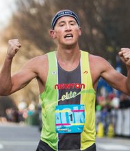 Men’s winner Tyler McCandless of Boulder, Colo., crosses the finish line with a time of 29:38.