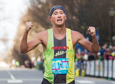 Men’s winner Tyler McCandless of Boulder, Colo., crosses the finish line with a time of 29:38.