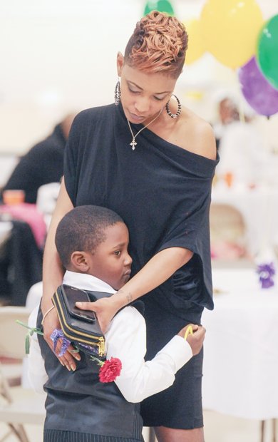 Tanya Wilkins, embraces her nephew, Messiah Gilliam-Cox, as they dance at the Mother/Son and Father/Daughter Red Carpet Dance sponsored by Richmond’s J.L. Francis Elementary School PTA.