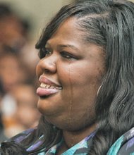 Carver Elementary School Principal Kiwana S. Yates, right, is all smiles as she is celebrated during a school assembly Wednesday for winning a 2015 R.E.B. Award for Distinguished Educational Leadership. She was one of four Richmond area principals to be honored by the R.E.B. Foundation in partnership with The Community Foundation. Mrs. Yates was joined by her husband, Darnell Yates, and her mother, Patricia Evans-Branch, at the assembly, where she was presented with a check for $15,000. Half of that is for her personal use. The other $7,500 will be used for educational field trips, she said. “I was very excited and surprised,” Mrs. Yates told the Free Press of the ceremony. “The fact that the staff and students were able to pull off such a wonderful event was priceless. This made my heart melt.”