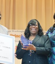 Carver Elementary School Principal Kiwana S. Yates, right, is all smiles as she is celebrated during a school assembly Wednesday for winning a 2015 R.E.B. Award for Distinguished Educational Leadership. She was one of four Richmond area principals to be honored by the R.E.B. Foundation in partnership with The Community Foundation. Mrs. Yates was joined by her husband, Darnell Yates, and her mother, Patricia Evans-Branch, at the assembly, where she was presented with a check for $15,000. Half of that is for her personal use. The other $7,500 will be used for educational field trips, she said. “I was very excited and surprised,” Mrs. Yates told the Free Press of the ceremony. “The fact that the staff and students were able to pull off such a wonderful event was priceless. This made my heart melt.”