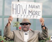 The Rev. Arthur Prioleau holds a sign during Wednesday’s demonstration outside the North Charleston, S.C., city hall.