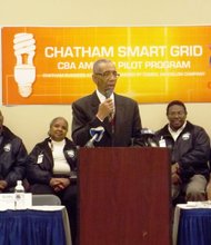 Michael McMahon, vice president of smart grid technology for ComEd, U.S. Cong. Bobby Rush (Dist.-1) and Melinda Kelly, Exec. Dir., Chatham Business Association. Back row seated, Dwain Geoghegan, Madeline Morgan, George Sims, Clifford Borner, II, participants in Chatham Business Association/ComEd, pilot, smart grid outreach, pilot training/employment program.
