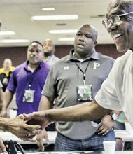 

Former Virginia State University Coach Lou Anderson, left, receives congratulations on his Lifetime Achievement Award by friend and fellow Coach Willard Bailey at Virginia Union University’s 2nd Annual Legends Clinic last Saturday. 