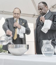VUU President Claude G. Perkins and the Rev. W. Franklyn Richardson, chairman of the VUU Board of Trustees, conduct a libation ceremony honoring the university’s forebearers. 
