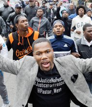 The Rev. Westly West leads demonstrators to the Baltimore Police Department’s Western District police station Wednesday to protest the death of Freddie Gray while in police custody.