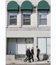 Pedestrians walk by the new home of Muhammad Mosque No. 24 at 408 E. Main St. in Downtown. No signs adorn the building to call attention to its new use as a place of worship.
