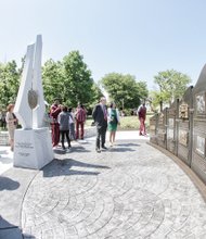 Virginia Union University President Claude G. Perkins and his wife, Cheryl, center, view a monument unveiled Wednesday to mark VUU’s 150th anniversary. Sculptor Ed Dwight of Denver spoke at the ceremony. One part of the monument tells VUU’s history, while the other portion contains the university’s insignia, along with the inscribed names of Dr. Perkins, trustee board members and honorary trustees.