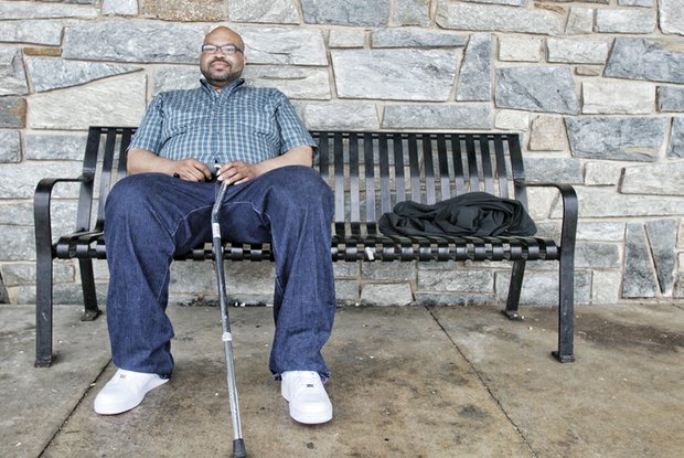 Roderyck Bullock waits patiently for one of GRTC’s CARE vans to take him home from the city’s Social Service Center on South Side. He only wishes, like many riders, that the service he relies on would be more reliable.