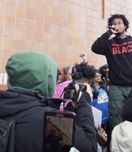Chicago Poet, Malcolm London, delivers a speech during Tuesdays peaceful demonstration in front of Chicago Police Headquarters.