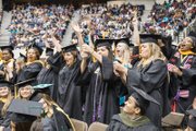 Members of the Virginia Commonwealth University Class of 2015 celebrate with confetti, noisemakers and cheering during Saturday’s commencement at the Richmond Coliseum.