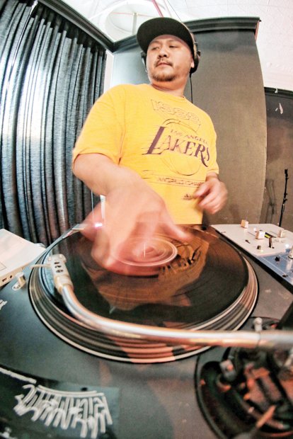 DJ Billy Nguyen provides music for the hip-hop celebration last Friday at Gallery 5 in the city’s Jackson Ward community. 
