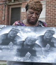 Joyce Kenney holds an image of her grandson, Ra’Keem Adkins, 22, who was shot and killed in the Mosby Court public housing community May 7. 