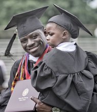 Like father, like son.  Justin White holds two of his proud accomplishments — his son, Jeremiah, and his newly earned degree from Virginia Union University. The father and son celebrated in cap and gown Saturday at the university’s 117th commencement ceremony at Hovey Field.