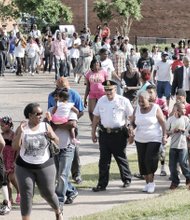 More than 200 people, including Richmond Police Chief Alfred Durham, march from Martin Luther King Jr. Middle School to Mosby Court calling for an end to the violence.