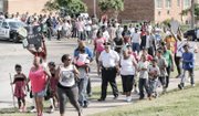 More than 200 people, including Richmond Police Chief Alfred Durham, march from Martin Luther King Jr. Middle School to Mosby Court calling for an end to the violence.