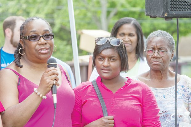 Members of Martin “Marty” Cobb’s family thank volunteers for their efforts constructing the playground. They are, from left, Marty’s aunt, Arleen Pitchford; his sister, Qutaya Cobb; and his grandmother, Mary Pitchford.