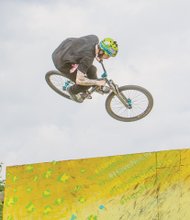 A biker flies through the air performing tricks