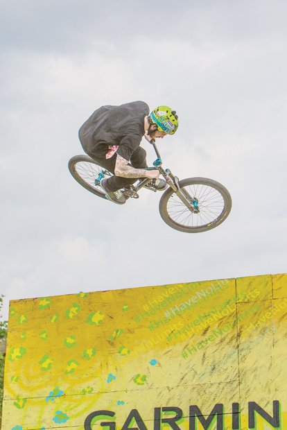 A biker flies through the air performing tricks