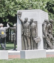 A passer-by gives a high-five to the likeness of Barbara Rose Johns at the Virginia Civil Rights Memorial at Capitol Square in Downtown. 
 Unveiled in 2008, the memorial celebrates Ms. Johns and others whose protests and lawsuits brought an end to the Jim Crow-mandated separation of black and white students in public schools. 
In 1951 at age 16, Ms. Johns led a student walkout from a decaying high school in Prince Edward County. The legal case that grew from that protest helped generate the U.S. Supreme Court’s landmark Brown v. Board of Education decision on May 17, 1954 — 61 years ago last Sunday.
That remarkable decision outlawed public school segregation and became a major step toward ending legal apartheid in this country.  
Other figures on the memorial include, front, the late NAACP attorneys Oliver W. Hill and Spottswood W. Robinson III, both of Richmond, who represented Ms. Johns and others in Prince Edward County and whose legal attack on segregation became part of the Brown case. Right, figures celebrate courageous Virginians who marched, protested and helped bring down segregation, serving as a reminder of the role of ordinary citizens in shaping public policy.