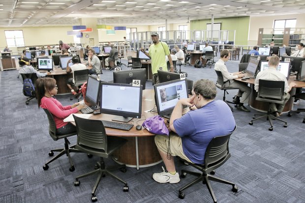 Main Library patrons work intently on computers on the second floor. The library now has 95 computers available to serve the public.