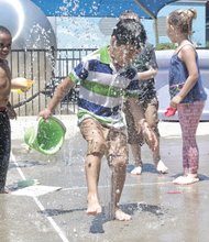 Children play Wednesday in water spraying at SplashMor, an interactive exhibit at the Children’s Museum of Richmond on West Broad Street. The young visitors from the Piedmont Family YMCA in Charlottesville had an early start on the Memorial Day holiday, which is considered the unofficial start of summer. The holiday, to be celebrated Monday, May 25, honors America’s war dead. With sunny skies forecast, the holiday also will feature cookouts, swim parties and other fun outdoor activities