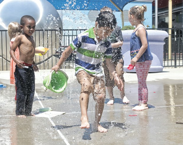 Children play Wednesday in water spraying at SplashMor, an interactive exhibit at the Children’s Museum of Richmond on West Broad Street. The young visitors from the Piedmont Family YMCA in Charlottesville had an early start on the Memorial Day holiday, which is considered the unofficial start of summer. The holiday, to be celebrated Monday, May 25, honors America’s war dead. With sunny skies forecast, the holiday also will feature cookouts, swim parties and other fun outdoor activities