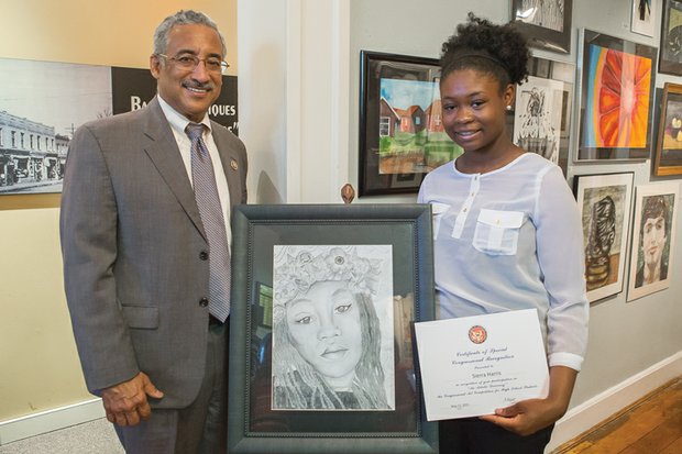 
Budding artist is official winner
Congressman Robert C. “Bobby” Scott presents Sierra Harris of Newport News and her winning work at Richmond’s Black History Museum and Cultural Center of Virginia. The Woodside High School student was named the winner of the 22nd annual 3rd Congressional District Art Competition. The competition is open to all high school students in the congressman’s district. It is part of An Artistic Discovery, a nationwide program coordinated by members of the U.S. House of Representatives to recognize the artistic talents of young people.
