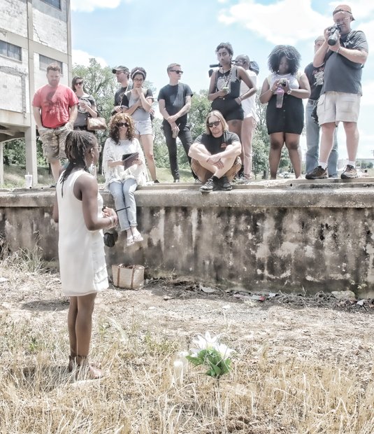 Darlene Scott, one of the event organizers, addresses the group after the Confederate flag was buried in a symbolic funeral Monday at Intermediate Terminal near the James River.
