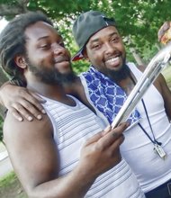 At Byrd Park, brothers Rashard and Winston Thornton check to see if the grilling chicken is done.