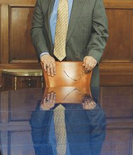 Mr. Boone stands in the Free Press board room. Below, he speaks to the Occupy Movement.