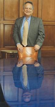 Mr. Boone stands in the Free Press board room. Below, he speaks to the Occupy Movement.