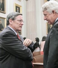 Chief Justice Donald W. Lemons, left, who presided at the court’s special session, talks with Attorney General Mark R. Herring, who spoke at the court session commemorating the ODBA’s 75th anniversary. 