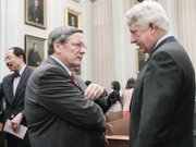 Chief Justice Donald W. Lemons, left, who presided at the court’s special session, talks with Attorney General Mark R. Herring, who spoke at the court session commemorating the ODBA’s 75th anniversary. 
