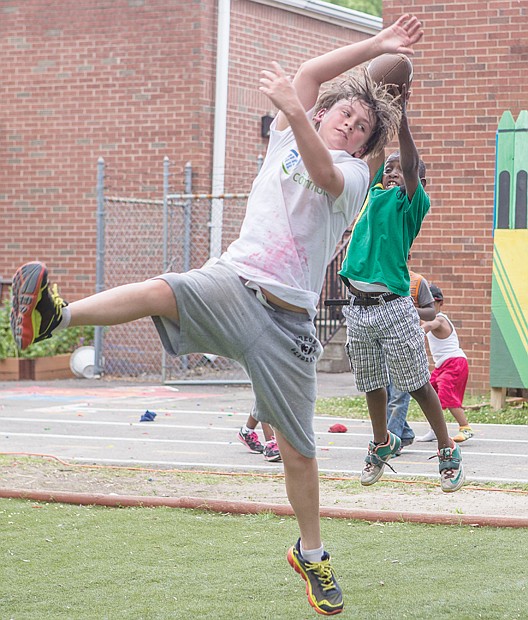 Jonathan Massenberg II doesn’t let height or age trump him. The youngster went airborne to snag the football missed by volunteer Aidin Gonzalez at the Friends Association for Children’s Community Health Fair last Saturday in Gilpin Court. In addition to cooking demonstrations, health screenings and fitness classes, the fair featured a Kids Fun Zone where youngsters tossed footballs, hurled water balloons and enjoyed face painting.