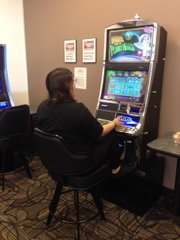 A patron tries her luck on a video gaming machine on Bonny's Bistro, one of many gaming cafes that are located in Joliet.