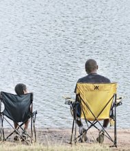 Cousins Kalen Gilliam, right, and Kynedy Jackson enjoy time together as they fish Saturday in Shields Lake at the annual Family Fishing Fair in Byrd Park. They were among hundreds of people who turned out on the beautiful sunny day to cast their lines. The event was organized by the city’s Department of Parks, Recreation and Community Facilities.