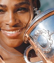 Serena Williams holds her trophy after winning the French Open championship Saturday in three sets at Roland Garros Stadium in Paris. It was her 20th Grand Slam title.